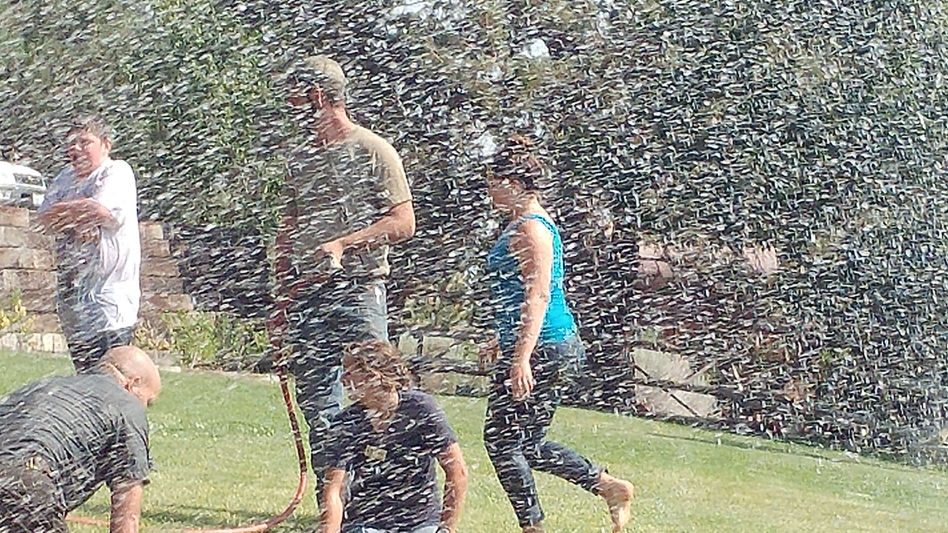 Image of water delivery truck onsite at water park people playing in water